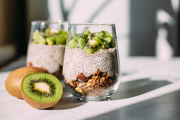 Chia seed pudding with kiwi and granola in glass