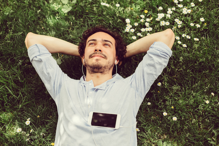 man relaxing in grass