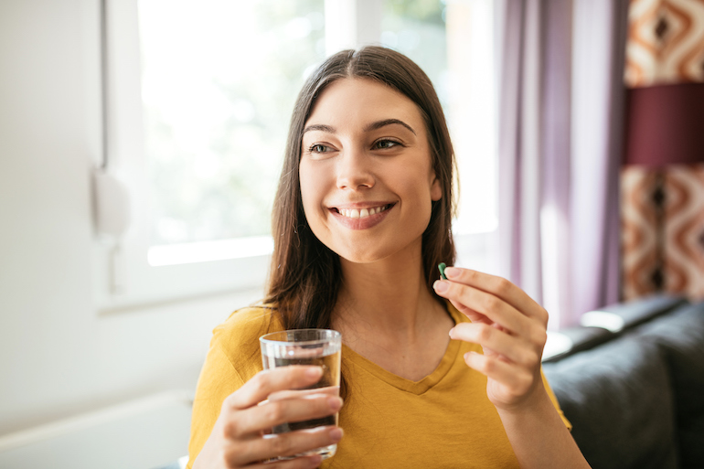woman taking a supplement