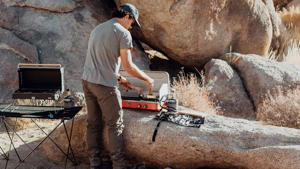 camp stoves man cooking with a camp stove