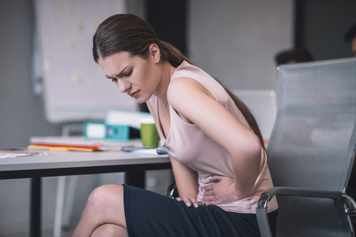 woman holding her belly from keto bloating and gas