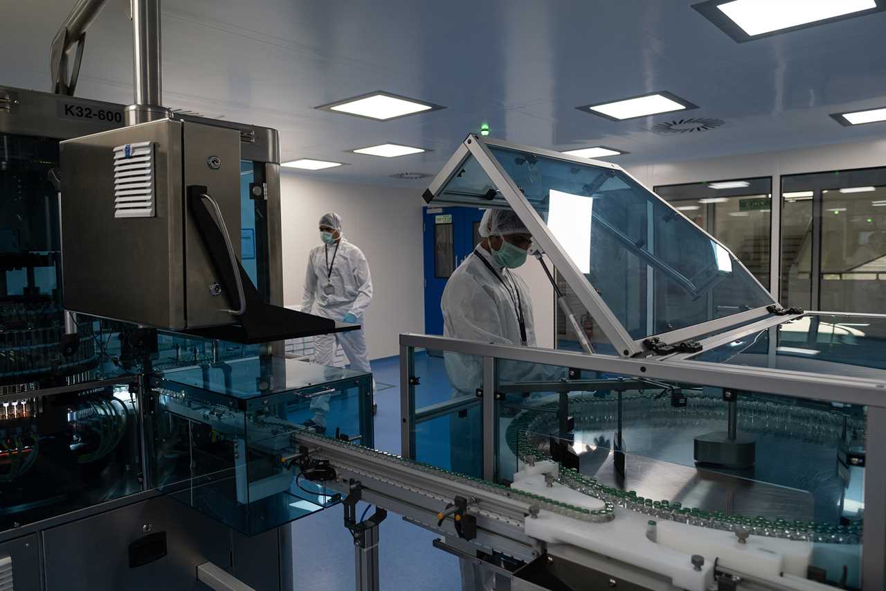 A worker organizes vials of AstraZeneca's Covid-19 vaccine at a Serum Institute of India facility in Pune on Sept. 22, 2021