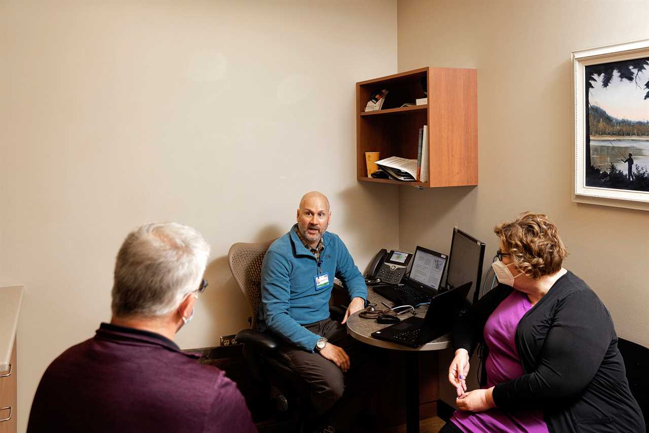 Dr. Brad Nieset talks with Mike and Amber Rausch after completing testing for Long COVID symptoms