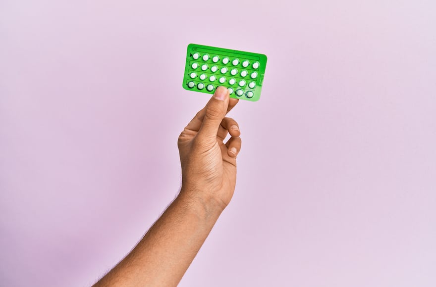 birth control and vitamin deficiency hand holding pill pack