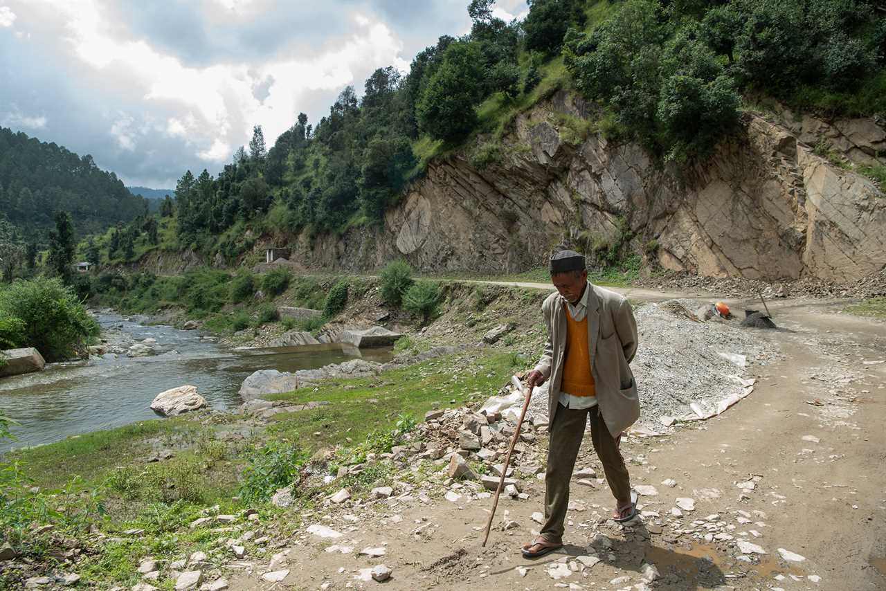 Jaikishan Ram, 77, treks back home after receiving a dose of the COVID-19 vaccine in Padampuri, India, on Sept.Â 3