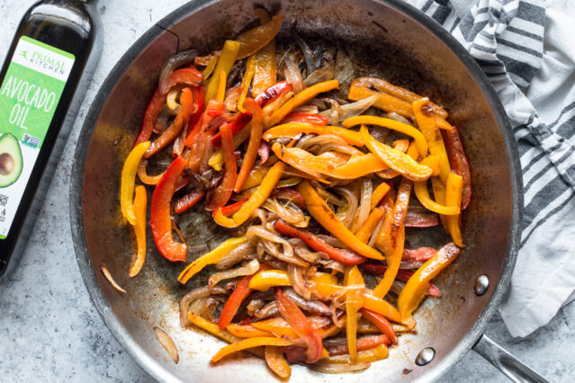 Caramelized onions and red and yellow bell peppers in pan, Primal Kitchen Avocado Oil