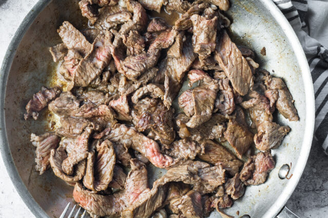 Sauteed steak strips in a pan