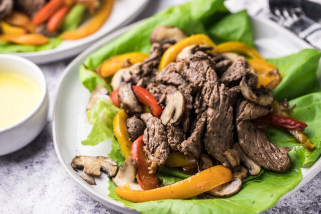 Philly cheesesteak meat and vegetables served on butter lettuce leaves, no cheese sauce