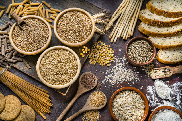 Assorted grains in bowls and spoons, bread, pasta