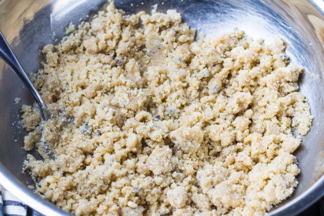 Macadamia bar batter in silver mixing bowl with spoon