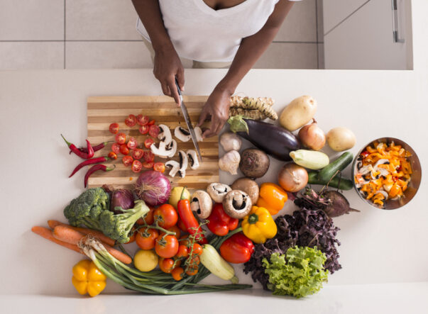 Unrecognized women preparing fresh healthy salad.