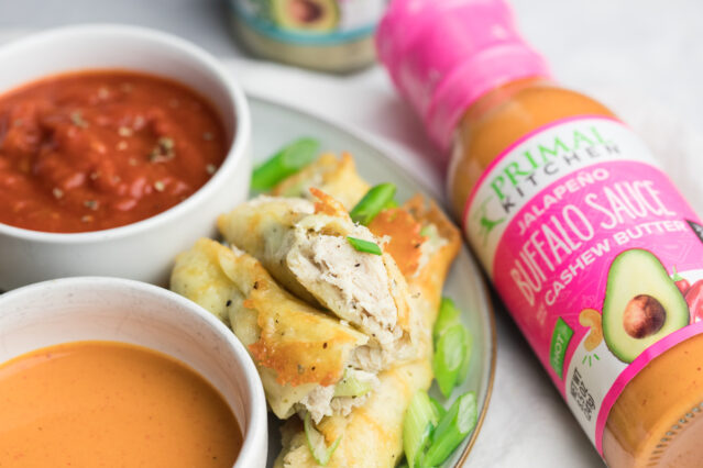 Buffalo chicken roll-ups on plate with Primal Kitchen Buffalo Sauce