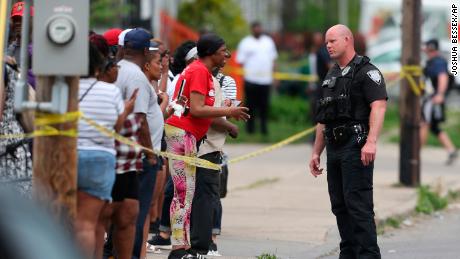 Police talk to passers-by after supermarket shooting on May 14, 2022 in Buffalo, New York.