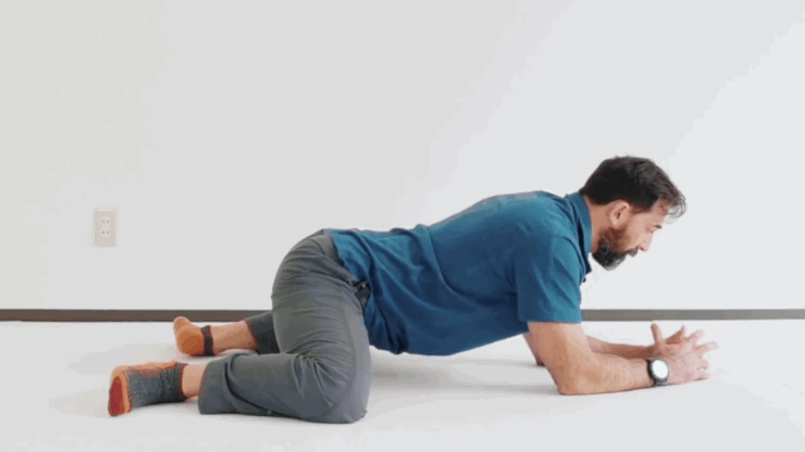Gif of man in blue polo and gray pants in frog pose.