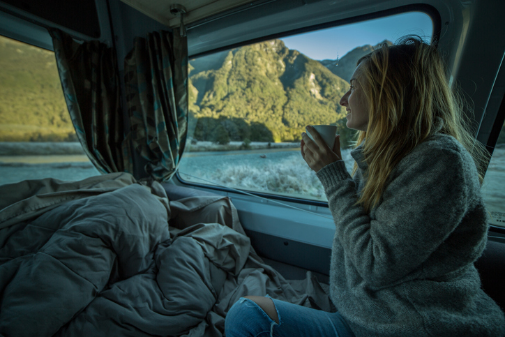 woman drinking yerba mate from her camper in the morning