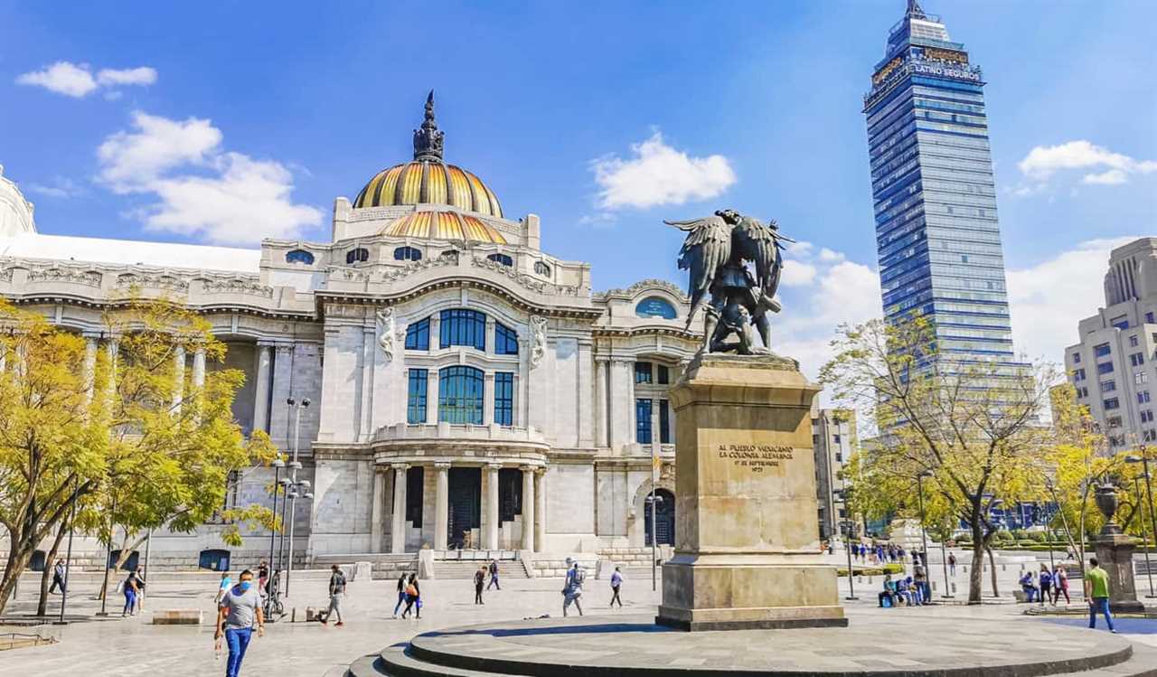 People enjoying a sunny day near historic buildings in Mexico City, Mexico