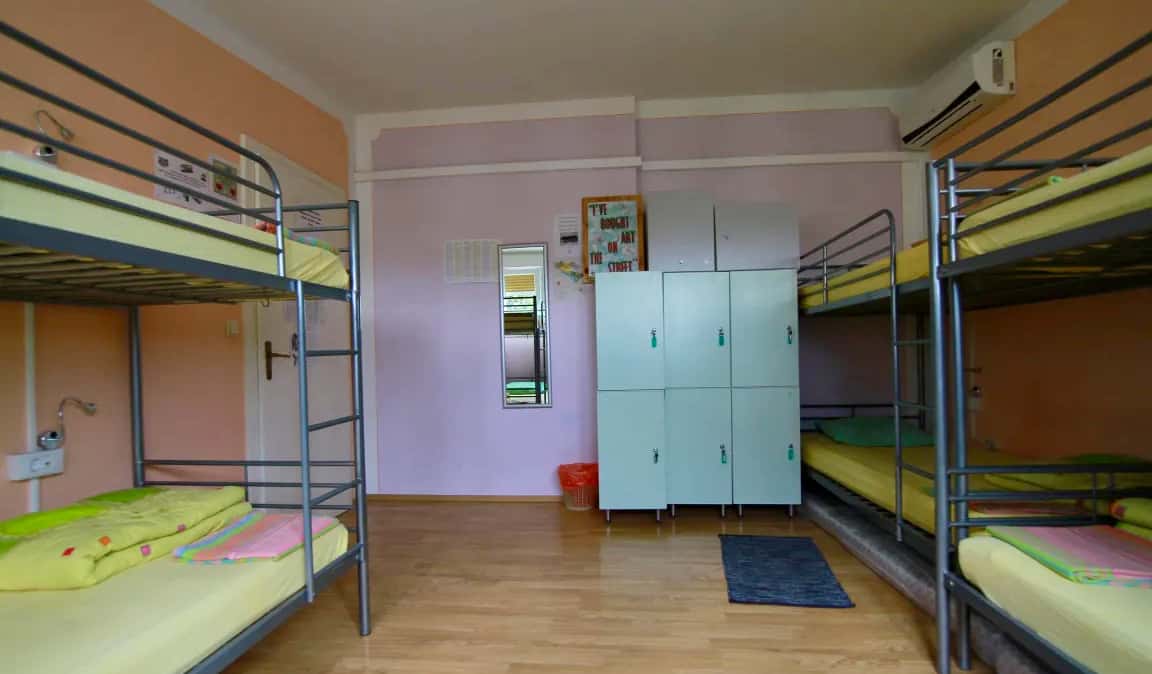 The interior of a large dorm with lockers and bunk beds in the Backpackers Fairytale Hostel in Split, Croatia