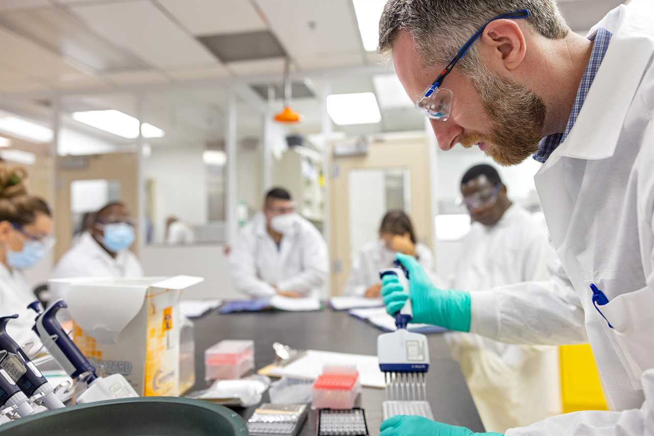 Laboratory technicians from members of the Abbott Pandemic Defense Coalition undergo training at AP8 in Abbott Park, Ill.