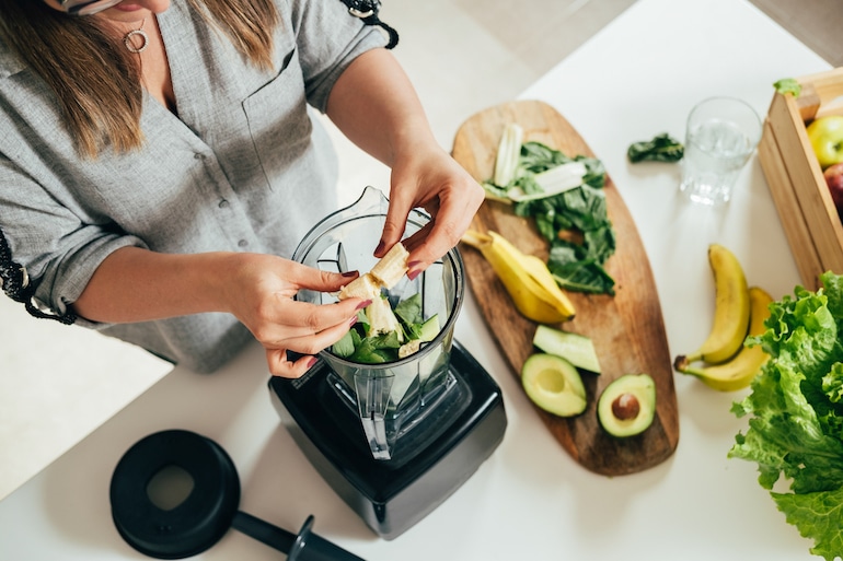 woman making a gut health smoothie