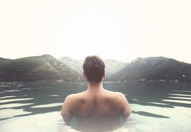 Man relaxing in a mountain lake