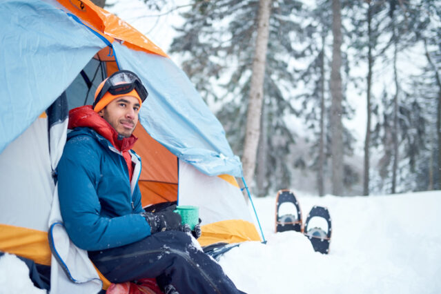 Man camping during the winter