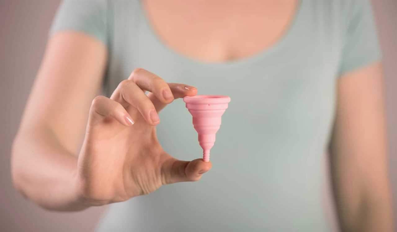 A menstrual cup being held by a woman