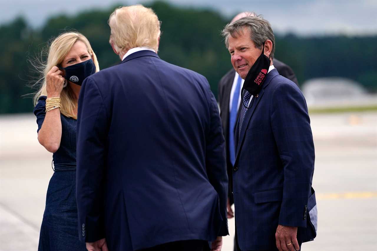 President Donald Trump greets Georgia Gov. Brian Kemp and his wife Marty as he arrives at Dobbins Air Reserve Base for a campaign event at the Cobb Galleria Centre, Sept. 25, 2020, in Atlanta. 