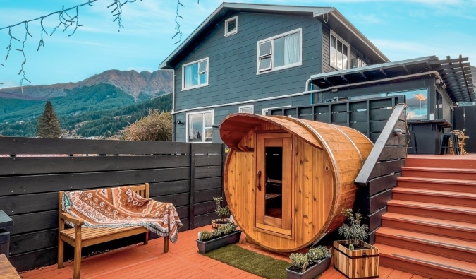 Spherical sauna on a deck with a large house in the background at Black Sheep Backpackers hostel in Queenstown, New Zealand