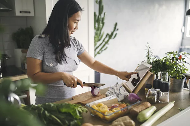Woman making a healthy, gut-friendly meal at home for her weight loss plan