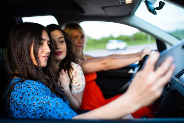 Girls taking group selfie in car to appear more attractive for dating