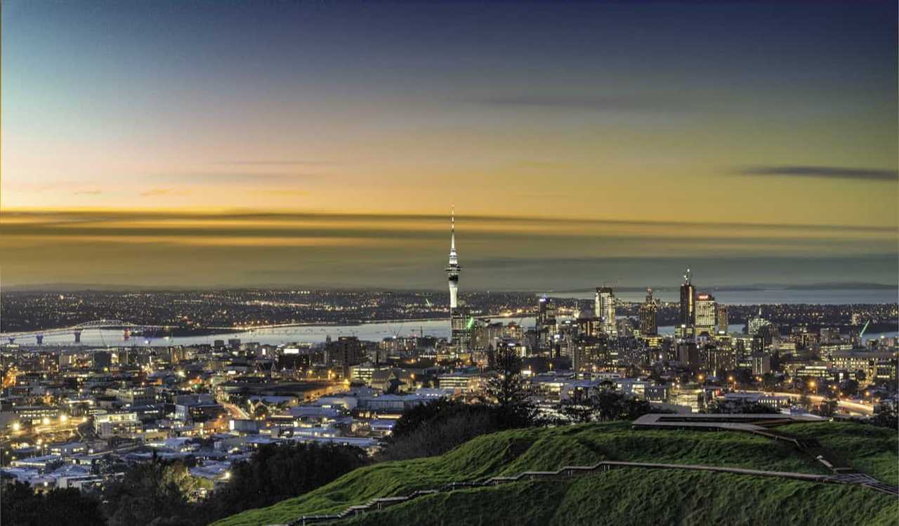 The stunning skyline of Auckland, New Zealand during a colorful dusk sunset