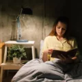 Woman reading in bed as part of her bedtime routine