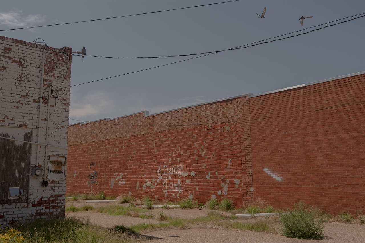 Graffiti reads "a dying town" on a wall in downtown LIttlefield, Texas on June 27, 2022.