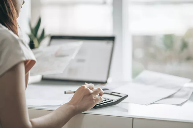 Woman getting her money in order by following financial wellness tips