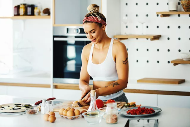 Woman preparing healthy food on a diet to balance ghrelin and leptin hormones