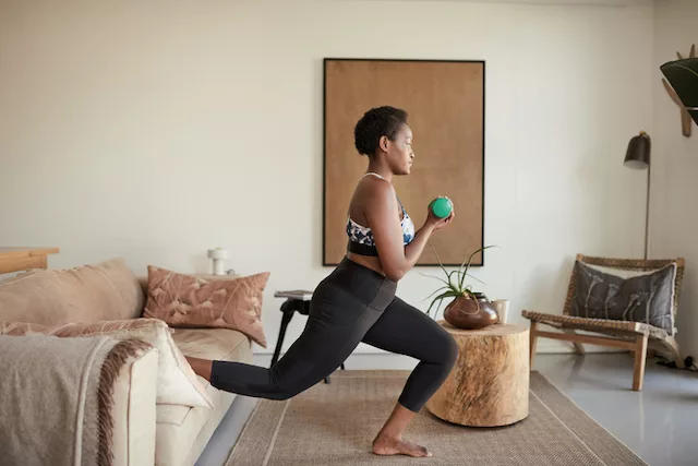 Woman doing strength training exercises at home