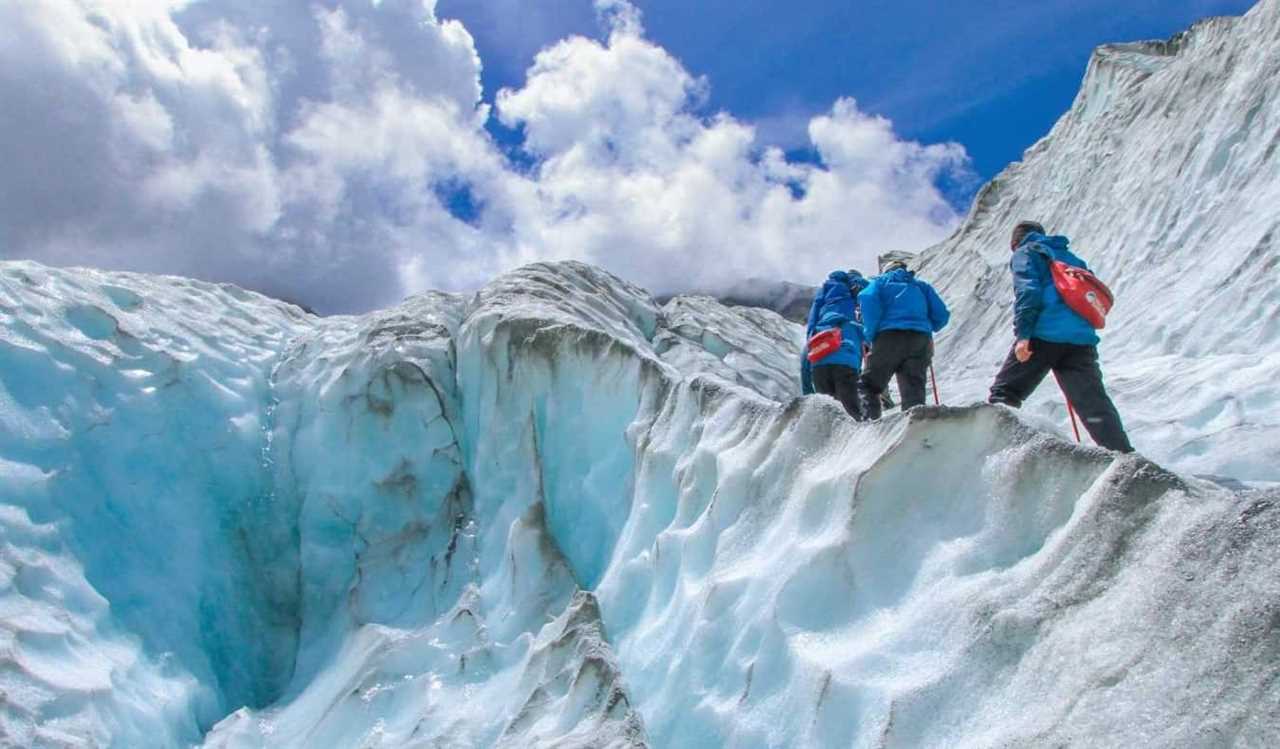 People hiking on a glacier in Franz Josef, New Zealand