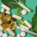 Personalized HUM vitamins and supplements on a spoon next to leaves on a bright green background, to demonstrate how to find the best vitamins for you