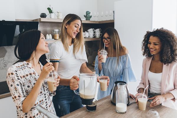 group of friends sharing a homemade smoothie | Coconut Milk Benefits