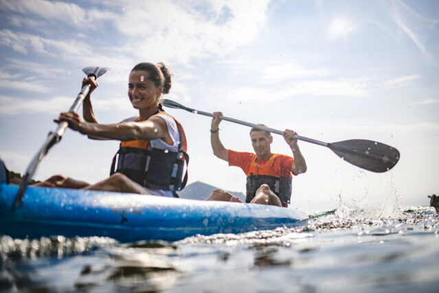 Man and woman paddling on kayak 