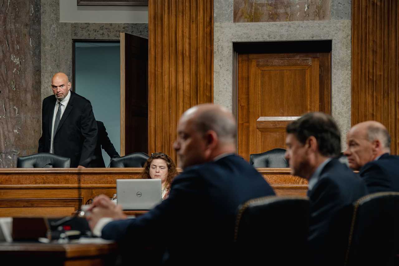 Senator John Fetterman enters a committee hearing room in the capitol