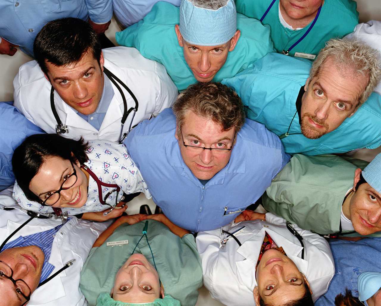 Group of healthcare professionals looking up, overhead view