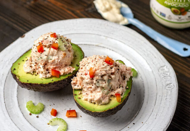 Avocado cut in half and filled with tuna salad, Primal Kitchen Mayo.