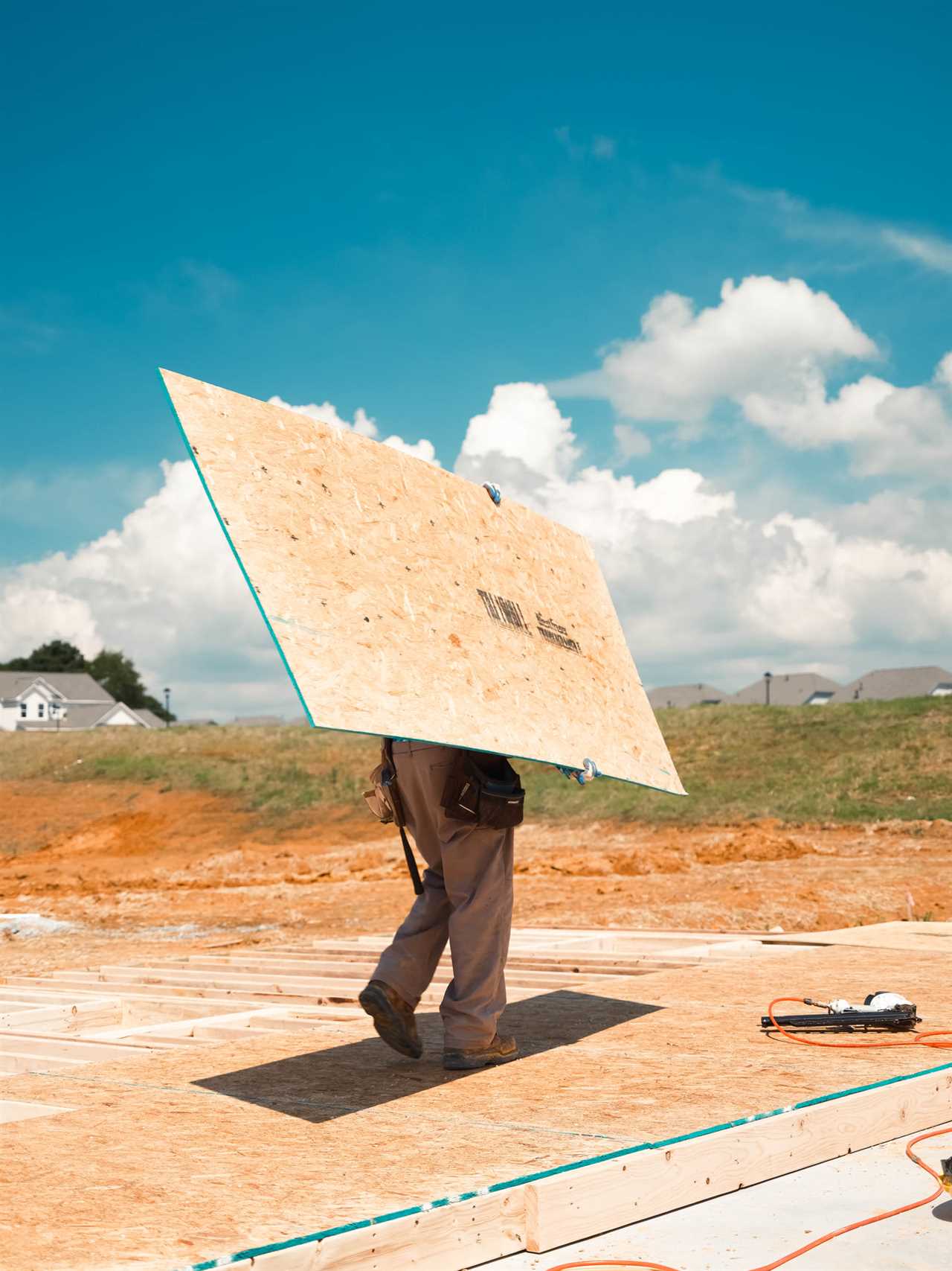 Construction workers toil in the heat working on a new subdivision being built in Loganville, Ga., in July 2023.