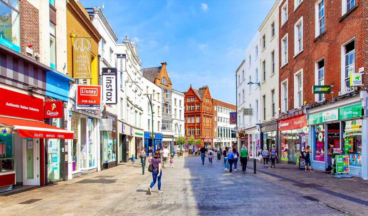 A sunny day in the Old Town of Dublin, Ireland as people walk around and shop