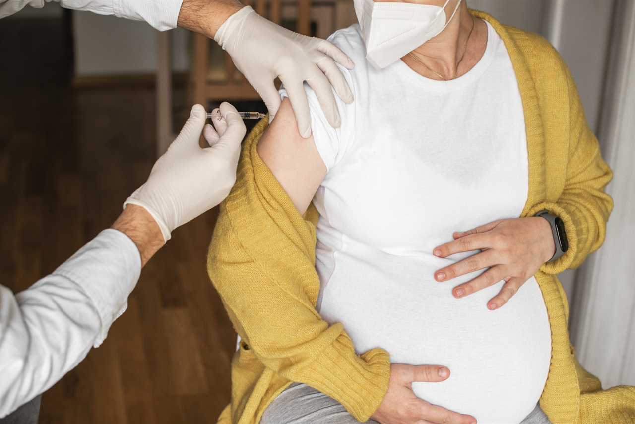 Pregnant woman taking a vaccination