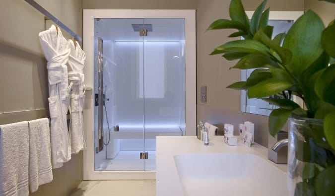 A spacious bathroom with a deep soaking tub and a separate shower at Crossing Condotti hotel in Rome, Italy