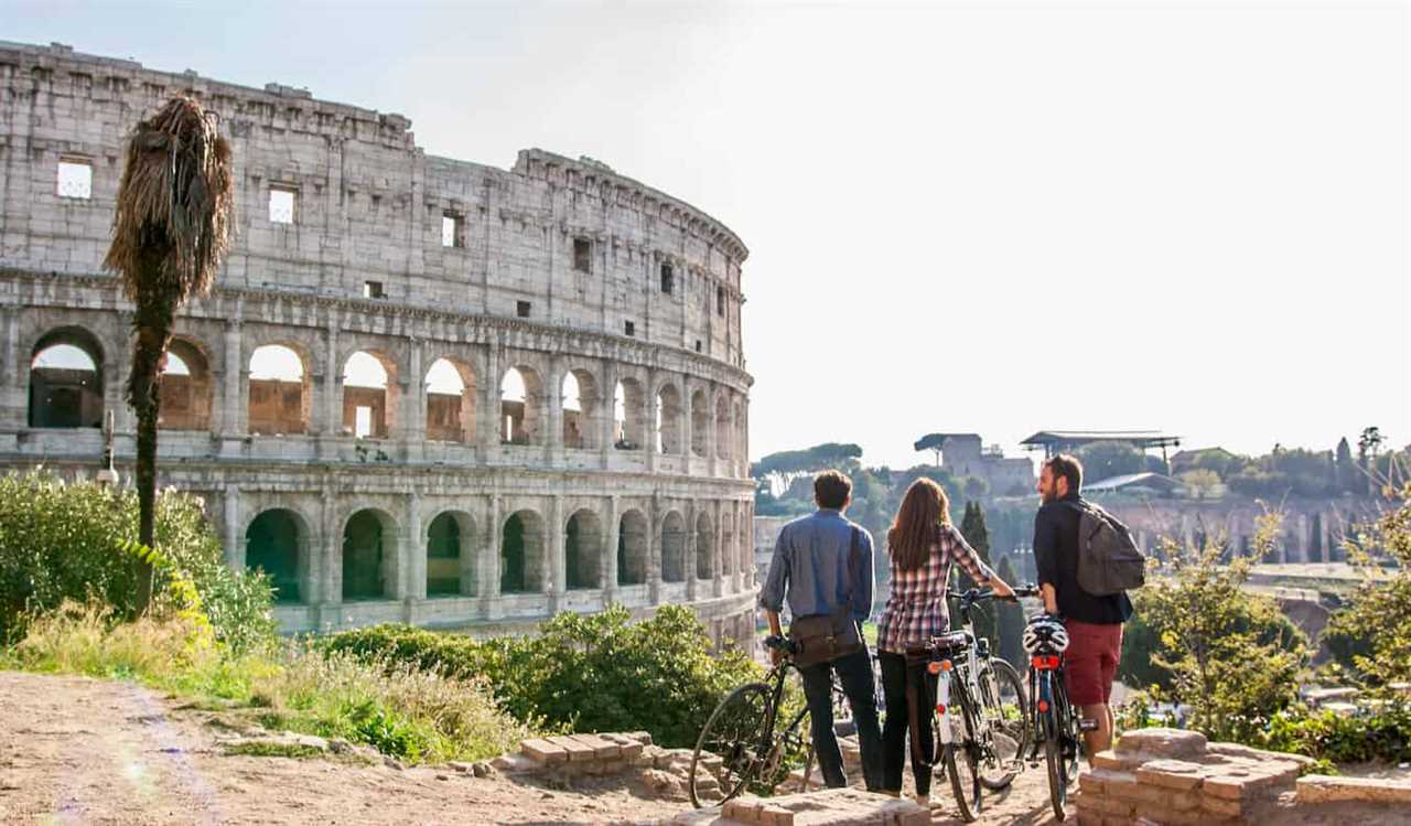 A group of travelers posing near the historic Colosseum in Rome, Italy