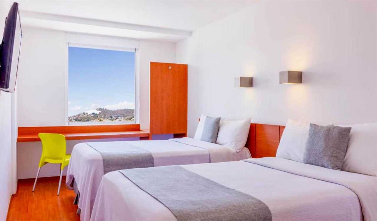 A simple, bright hotel room at One Oaxaca Centro hotel in Oaxaca, Mexico