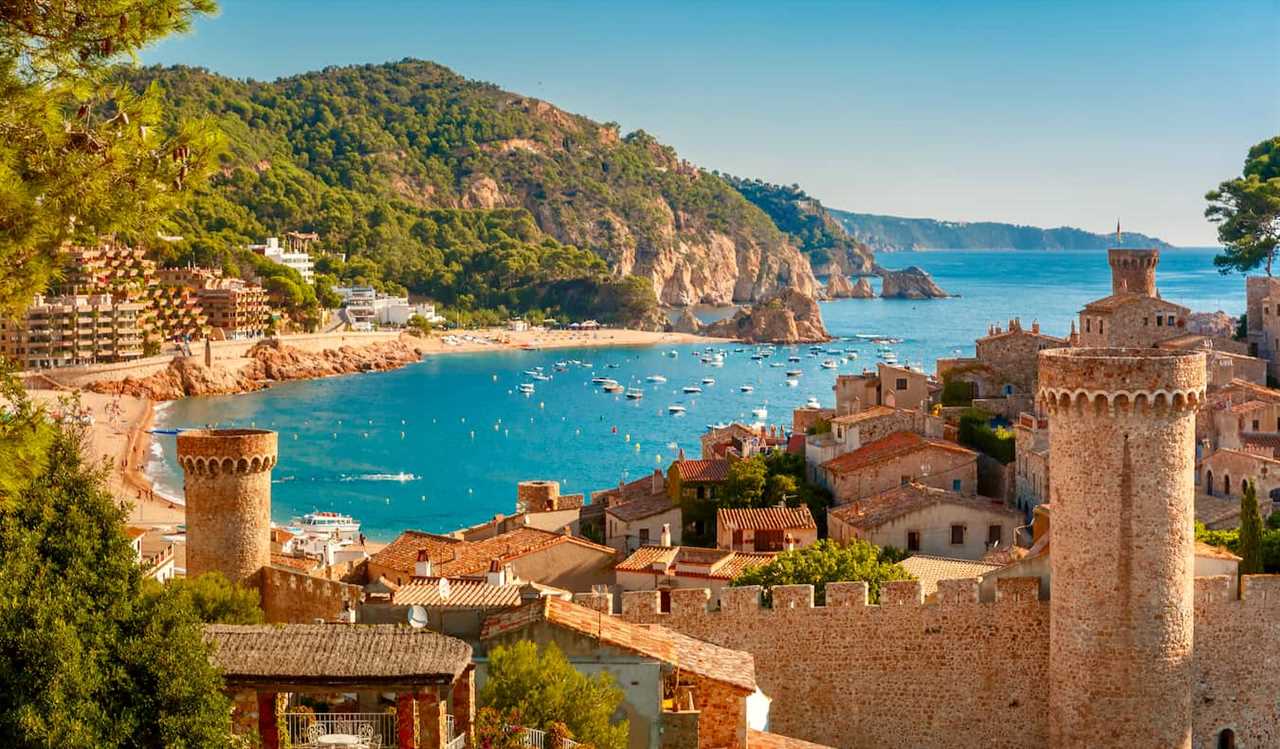 A scenic view over the historic walled area of a city in sunny Spain during a summer day